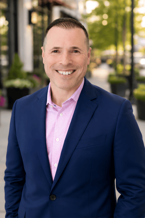 Rod Rochowiak, Principal at Agent Contract Services, standing on a tree lined street